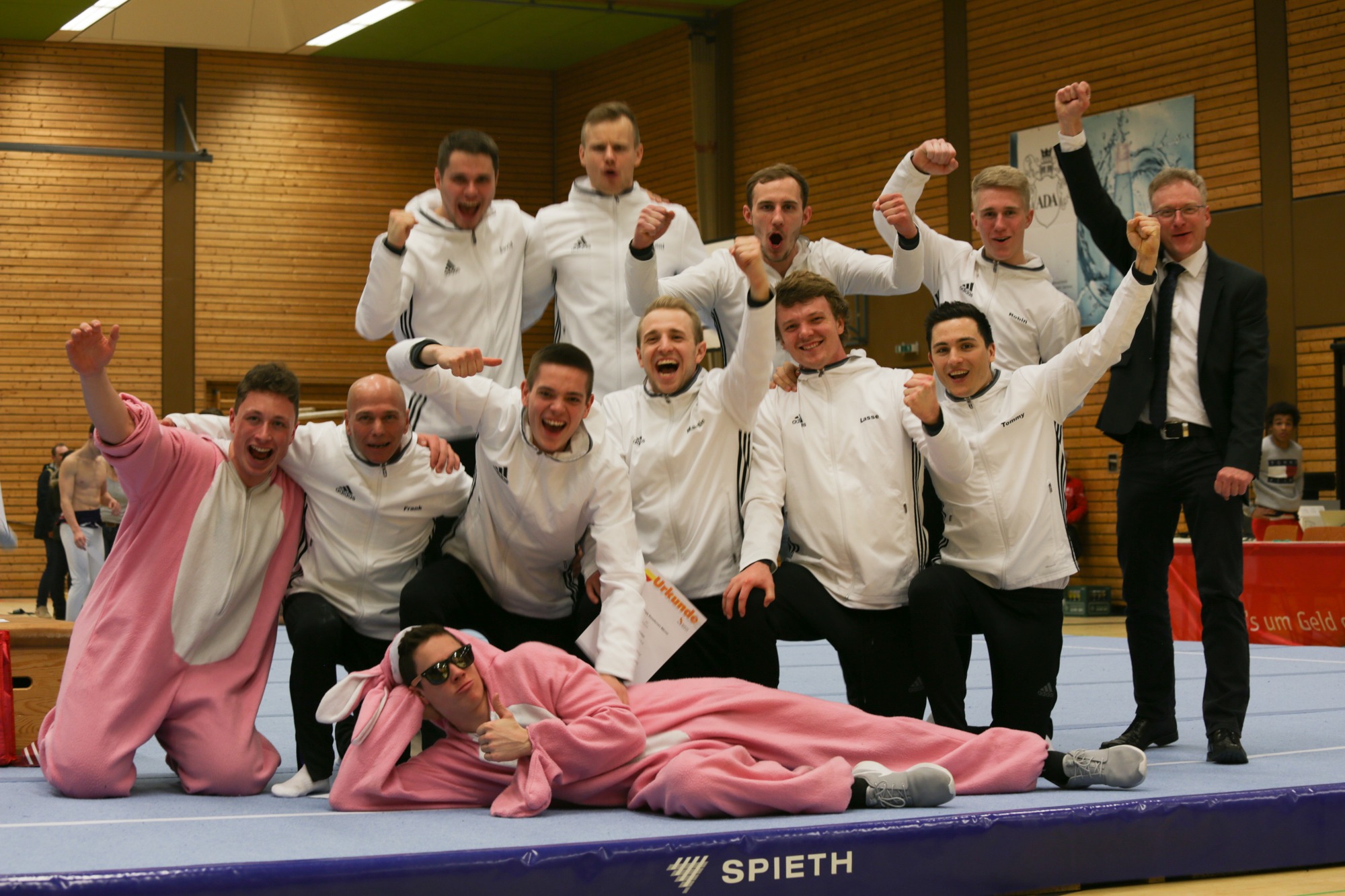 Oberliga_2018_16 Turner des TV Wolfenweiler-Schallstadt in weißen Trainingsanzügen jubeln nach dem Oberliga-Wettkampf 2018